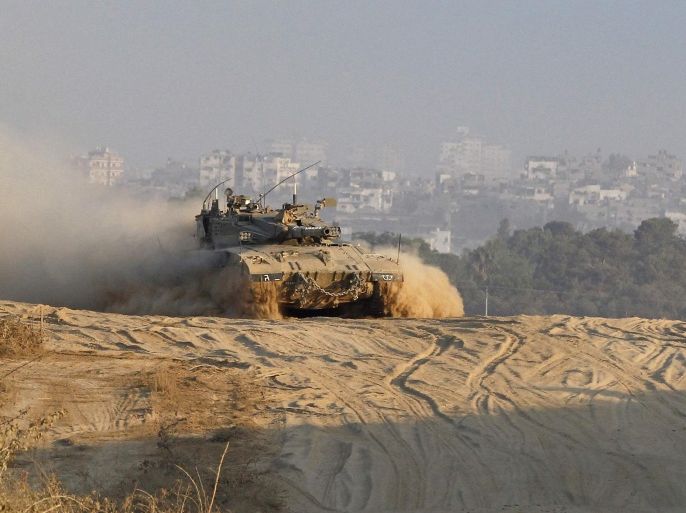 An Israeli military tank returns to a staging area in Israel after leaving Gaza August 3, 2014. Israel on Sunday declared dead soldier Hadar Goldin, feared abducted by Hamas Islamist militants in the Gaza Strip and said it would continue to fight even after the army completes destroying cross-border tunnels used by Palestinian fighters to attack its territory. Hamas' armed wing said on Saturday it had no clear indication on Goldin's whereabouts and that he may have been killed during an ambush in the southern Gaza Strip in which two other Israeli soldiers were killed. REUTERS/Siegfried Modola (ISRAEL - Tags: CIVIL UNREST MILITARY POLITICS CONFLICT)