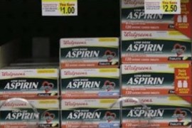 Packages of aspirin fill the shelves of a drugstore, Tuesday, Aug. 11, 2009 in Chicago. A study suggests colon cancer patients who took aspirin reduced their risk of death from the disease by nearly 30 percent.