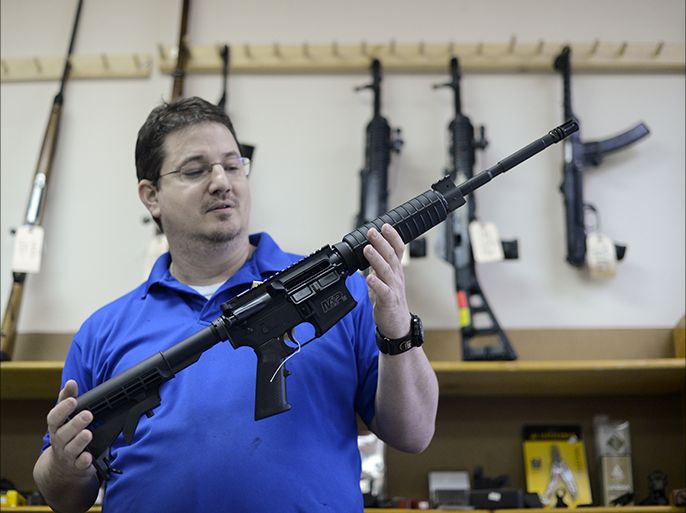 epa03514401 Ron Moon, co-owner of CJI Guns, holds a Smith & Wesson MP15 assault style semi-automatic rifle at his store in Tucker, Georgia, USA, 19 December 2012. The rifle is the same AR15 style weapon used in the Newtown, Connecticut, Sandy Hook Elementary school shooting on 14 December. US President Barack Obama on 19 December delivered remarks at the White House on policies to address gun violence, just days after a mass shooting at a Connecticut elementary school. Obama also named Vice President Joe Biden to lead a task force to examine potential tougher gun laws and other measures. The killings in Newtown of 20 children aged 6 and 7, along with six adults in a school and the gunman's mother have led to a national debate on US gun laws and mental health care. EPA/ERIK S. LESSER