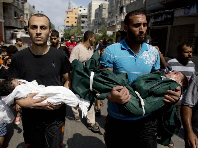 Al-Bakin family members carry the bodies of three year-old Kamal and four month-old Asma during their funeral in Gaza City, Monday, Aug. 5, 2014. The children were killed along with another family member in an Israeli missile strike on their home in the Shati refugee camp, Gaza City, on Monday. (AP Photo/Dusan Vranic)