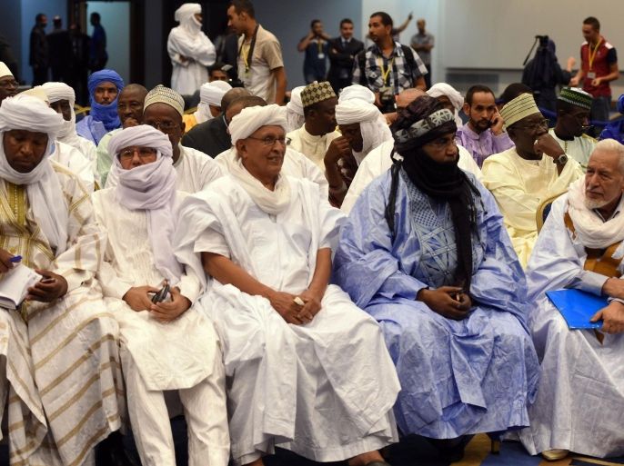 Members from the National Movement for the Liberation of Azawad (MNLA) attend the opening of peace talks on September 1, 2014 in Algiers between the Malian government and armed rebels, which are the second round of negotiations since July aimed at clinching a lasting peace agreement. The Bamako government and six rebel groups, mostly Tuareg but also including Arab organisations, are seeking to resolve a decades-old conflict that created a power vacuum in the desert north that was exploited by Al-Qaeda. AFP PHOTO / FAROUK BATICHE