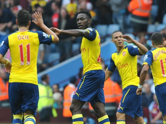 Arsenal's Danny Welbeck, 2nd left, celebrates with Mesut Ozil after scoring against Villa during the English Premier League soccer match between Aston Villa and Arsenal at Villa Park, Birmingham, England, Saturday, Sept. 20, 2014. (AP Photo/Rui Vieira)