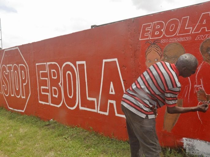 A local Liberian artist paints a mural forming part of the country's fight against the deadly Ebola virus by education in the city of Monrovia, Liberia, Tuesday, Sept. 23, 2014. U.S. health officials Tuesday presented worst-case and best-case scenarios for the Ebola epidemic in West Africa, calculating that as many as 1.4 million people could be sickened in two countries alone by mid-January _ or the outbreak could be winding down by then, if control efforts substantially increase. (AP Photo/Abbas Dulleh)