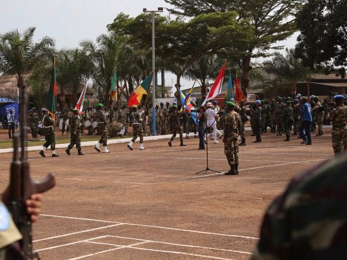 United Nations peace keeping troops take part in a ceremony in the capital city of Bangui, Central African Republic, Monday, Sept. 15, 2014. The United Nations took over a regional African peacekeeping mission in Central African Republic on Monday, Sept. 15, nine months after sectarian violence erupted that has left at least 5,000 people dead and has forced tens of thousands of Muslims to flee into exile in neighboring countries. (AP Photo)