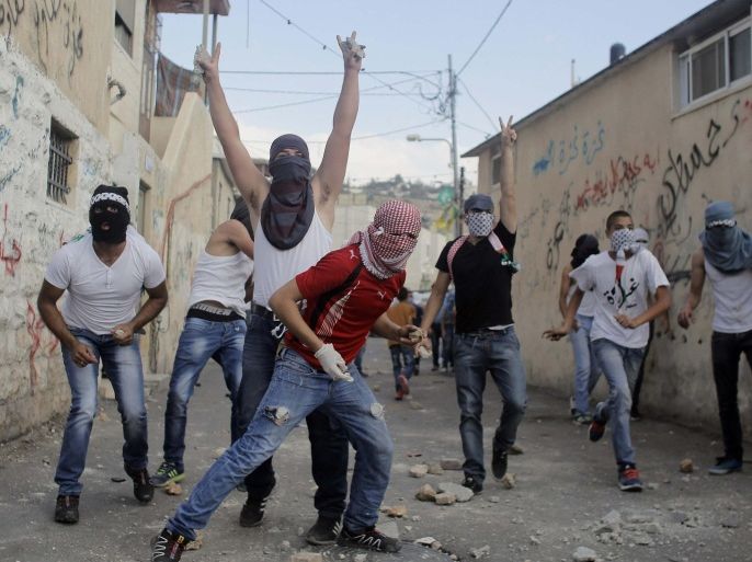 Palestinians hurl stones during clashes with Israeli police in the East Jerusalem neighbourhood of Wadi Joz September 7, 2014. Scores of Palestinians rioted in Israeli-occupied East Jerusalem on Sunday after news that a youth, Mohammed Sinokrot, had died of wounds suffered in a clash with Israeli police last week. There were no reports of serious injury in Sunday's unrest. Protesters in the neighbourhood of Wadi Joz close to the walled Old City, threw rocks, petrol bombs and flares at passing cars, and riot officers responded with rubber bullets during an afternoon of clashes that lasted hours. REUTERS/Ammar Awad (JERUSALEM - Tags: POLITICS CIVIL UNREST)