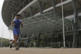 In this Thursday, Sept. 11, 2014 photo, a man runs around Gelora Bung Karno Stadium in Jakarta, Indonesia. Indonesian officials are confident they will return from the Asian Games in Incheon, South Korea, with confirmation that their country will host the next edition of the continental event, pitching a two-city event that could be staged a year ahead of schedule. Vietnam initially was awarded the rights to stage the Asian Games in 2019, but backed out in April citing a lack of funds. Indonesia, Southeast Asia’s largest nation and home to a fast-growing economy, has since emerged as the strongest candidate to host the event. (AP Photo/Achmad Ibrahim)