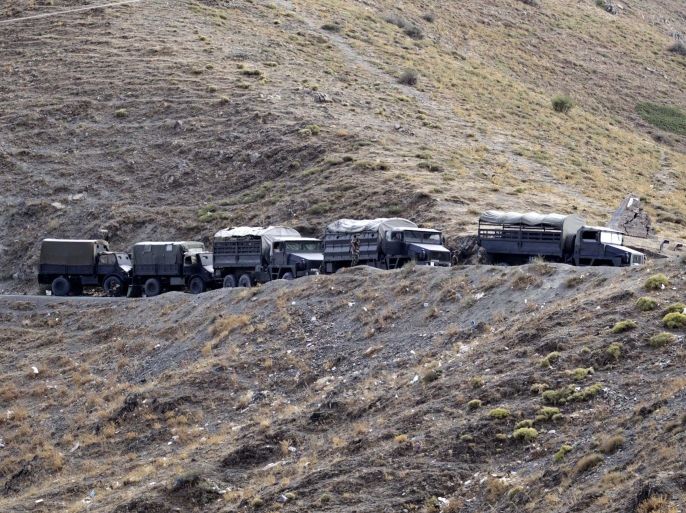 Algerian military vehicles are seen on a mountain near the village of Ait Ouabane, where a Frenchman was kidnapped by militants on Sunday, southeast of Algiers September 23, 2014. Algerian military and police set up checkpoints and sent troops into mountains east of Algiers on Tuesday to look for the Frenchman kidnapped by militants who threatened to execute him over France's intervention in Iraq. The Caliphate Soldiers, a splinter group linked to Islamic State militants in Iraq and Syria, on Monday published a video claiming responsibility for the abduction and showed a man identifying himself as Herve Gourdel, a tourist from Nice. REUTERS/Louafi Larbi (ALGERIA - Tags: POLITICS CIVIL UNREST CONFLICT MILITARY)