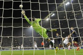 Germany's Thomas Mueller, right, scores the opening goal against Scotland's goalkeeper David Marshall during the Euro 2016 soccer qualifying group D match between Germany and Scotland in Dortmund, Germany, Sunday, Sept. 7, 2014. (AP Photo/Martin Meissner)