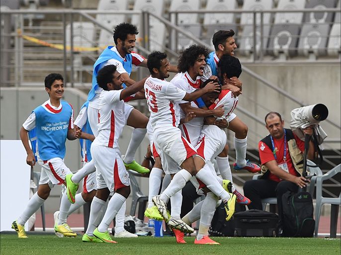 United Arab Emirates (UAE) players celebrate their second goal against Vietnam during their men's round of 16 football match of the 2014 Incheon Asian Games, at Hwaesong Sports Complex some 50km from Incheon on September 26, 2014. UAE won 2-1. AFP PHOTO / Ed Jones