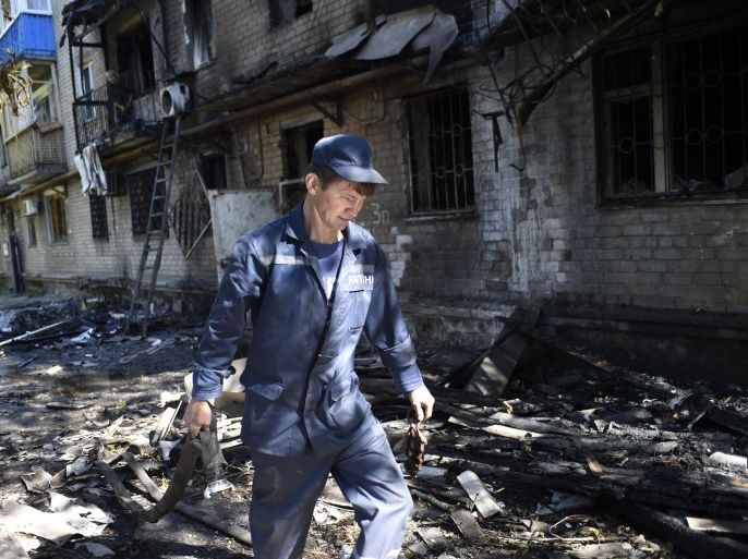 A firefighter walks in the rubble of a building destroyed by shelling this morning in the Kievsky district near the international airport on September 17, 2014 in Donetsk, eastern Ukraine. Two civilians were killed in fighting in the rebel-held eastern Ukrainian city of Donetsk, where fierce battles were raging near the airport on Wednesday, city hall said. AFP PHOTO/PHILIPPE DESMAZES