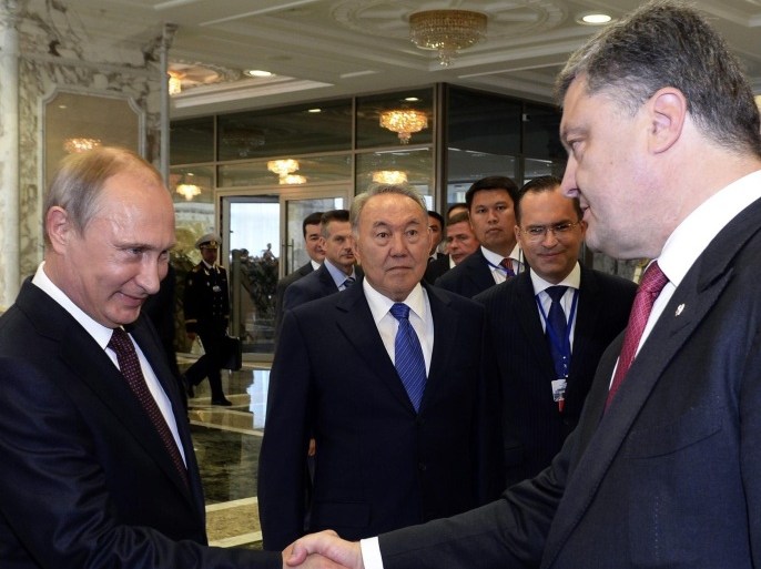 (FILE) A file photo dated 26 August 2014 of Russian President Vladimir Putin (2-L) shaking hands with Ukrainian President Petro Poroshenko (R) as Kazakh President Nursultan Nazarbayev (C) looks at them prior their talks in Minsk, Belarus. Media reports on 03 September 2014 state that the presidents of Ukraine and Russia, Petro Poroshenko and Vladimir Putin, agreed on a permanent ceasefire, according to Poroshenko's office. The agreement was reportedly reached during a telephone conversation.
