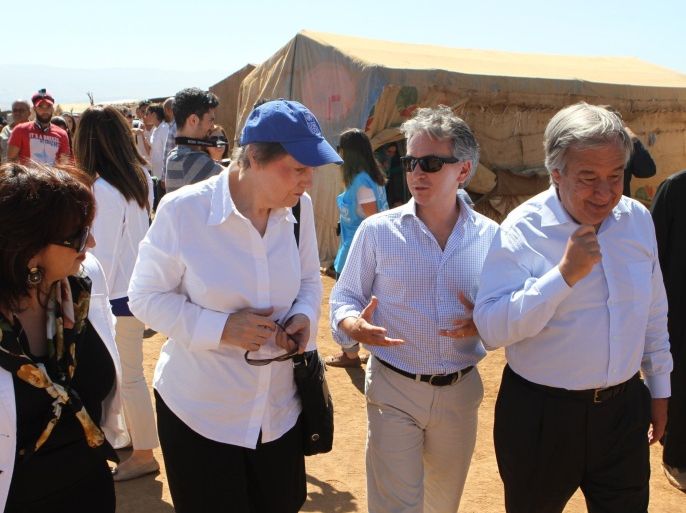 United Nations Development Programme (UNDP) head Helen Clark (L) and the United Nations High Commissioner for Refugees (UNHCR) High Commissioner Antonio Guterres (R) visit affected Lebanese host communities and Syrian refugees in Lebanon's Bekaa valley village of Deir al-Ahmar on September 16, 2014. There are more than 1.1 million Syrian refugees in Lebanon, which has a population of just four million people. AFP PHOTO/STR