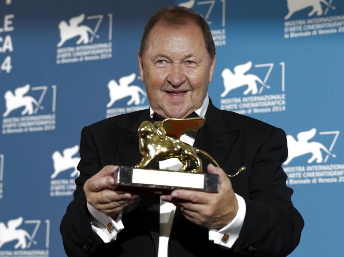 Director Roy Andersson shows his golden lion for the best film for his movie A Pigeon Sat On A Branch Reflecting On Existence during a photo call at the 71th edition of the Venice Film Festival in Venice, Italy, Saturday, Sept. 6, 2014. (AP Photo/Andrew Medichini)