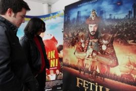 Young Turks look at an advertisement for "Conquest 1453" displayed outside a cinema in Ankara, Turkey, Wednesday, Feb. 29, 2012. Turkey is on a roll these days, uplifted by economic growth and regional diplomacy. Now comes a film to boost the feel-good mood, an epic about the 15th century fall of Constantinople that fuses Turkish nationalism with Hollywood-style ambition. "Fetih 1453," or "Conquest 1453," casts good guys (read Muslim Ottomans) against bad guys (aka Christian Byzantines), transforming a clash of empires and religions into a duel between right and wrong.