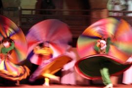 Egyptian dancers spinning a tanoura skirt during Ramadan Festival at Al Ghoury Palace in Cairo, Egypt, early on 10 July 2014. Al Tanoura is usually practiced by Sufi Muslims and is a spiritual practice where spinning and discarding three skirts represents the circular movement of the world.