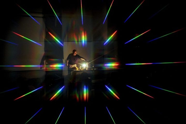 Viewed through a pair of prismatic glasses over the camera lens, physics professor Dr. Dan Bruton is surrounded by a rainbow of refracted light during a demonstration, Wednesday, Aug. 6, 2014, at Stephen F. Austin State University in Nacogdoches, Texas. The Science, Technology, Engineering and Mathematics (S.T.E.M.) program at the college hosted local Cub Scouts to introduce them to the multidisciplinary program. (AP Photo/The Daily Sentinel, Andrew D. Brosig) MANDATORY CREDIT