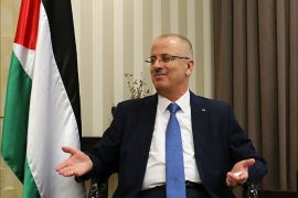 Palestinian Prime Minister Rami Hamdallah gestures during an interview with AFP at his office in the West Bank city of Ramallah on September 7, 2014. Prime Minister Hamdallah told AFP that his government has been threatened with a "boycott"