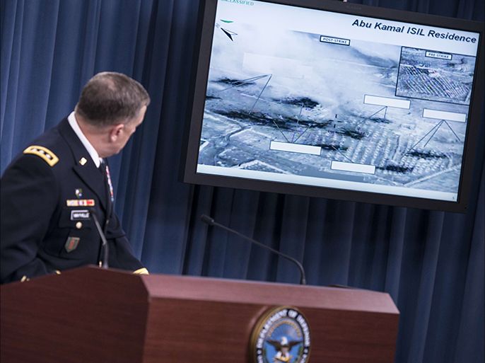 Lt. Gen. William C. Mayville Jr., Joint Staff Director of Operations Director of Operations, shows before and after images of airstrikes in Syria during a briefing at the Pentagon September 23, 2014 in Washington, DC. Mayville briefed the press about US and Arab nation joint airstrikes against Islamic State group targets in Syria and unilateral airstrikes against an al-Qaeda group in Syria. AFP PHOTO/Brendan SMIALOWSKI
