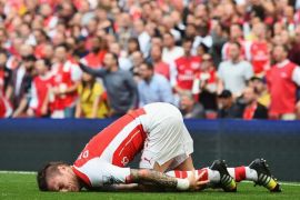 LONDON, ENGLAND - SEPTEMBER 13: Mathieu Debuchy of Arsenal is injured in the first half during the Barclays Premier League match between Arsenal and Manchester City at Emirates Stadium on September 13, 2014 in London, England.