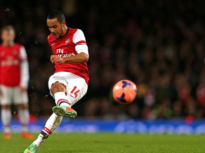 LONDON, ENGLAND - JANUARY 04: Theo Walcott of Arsenal takes a shot on goal during the Budweiser FA Cup match between Arsenal and Tottenham Hotspur at Emirates Stadium on January 4, 2014 in London, England.