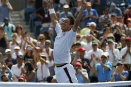 Kei Nishikori of Japan celebrates after defeating Novak Djokovic of Serbia in their semi-final match at the 2014 U.S. Open tennis tournament in New York, September 6, 2014. REUTERS/Mike Segar (UNITED STATES - Tags: SPORT TENNIS TPX IMAGES OF THE DAY)