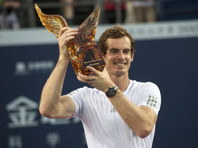 In this photo released by China's Xinhua news agency, Andy Murray of Britain poses with his trophy during the award ceremony after winning the final match against Spain's Tommy Robredo at the Shenzhen Open tennis tournament in Shenzhen, south China's Guangdong Province, Sunday, Sept. 28, 2014. (AP Photo/Xinhua, Mao Siqian) NO SALES