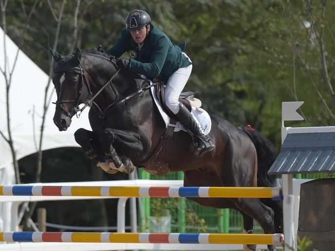 Saudi Arabia's Abdullah Waleed A Sharbatli astride horse Callahan jumps over an obstacle during the equestrian jumping individual final at the Dream Park Equestrian Venue of the 2014 Asian Games in Incheon on September 30, 2014. AFP PHOTO / PORNCHAI KITTIWONGSAKUL