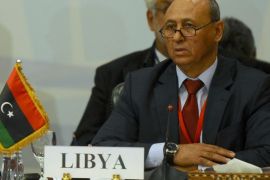 Libyan Foreign Minister Mohammed Abdel Aziz attends the Fourth Ministerial Meeting for the Neighbouring Countries of Libya in Cairo, August 25, 2014. The meeting aims to address latest developments in the security and political situation in Libya. Rockets hit Labraq airport in eastern Libya on Monday, its director said, striking one of the oil producer's few still functioning airports as violence between armed groups escalates. Lying east of Benghazi, Labraq has become a main gateway into Libya since Egypt and Tunisia cancelled almost all flights to the capital Tripoli and western Libya last week, citing security reasons. REUTERS/Stringer (EGYPT - Tags: POLITICS CIVIL UNREST CONFLICT)
