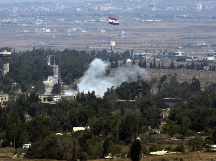 Smoke rises near a Syrian flag hoisted up a flagpole as a result of the fighting between Syrian rebels and Syrian Army over the control of Quneitra crossing, 29 August 2014. A group of 43 UN peacekeepers from Fiji being detained by militant rebels in Syria is safe, as negotiations with their captors for their release continues, Fijian Prime Minister Frank Bainimarama said. Rebels, believed to belong to the al-Qaeda-linked al-Nusra Front, captured the Fijian soldiers the previous day on the Syrian side of the Golan Heights, along the border with Israel.