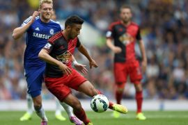 Swansea City’s Neil Taylor, right, and Chelsea’s Andre Schurrle battle for the ball during their English Premier League soccer match at Stamford Bridge, London, Saturday, Sept. 13, 2014. (AP Photo/Tim Ireland)