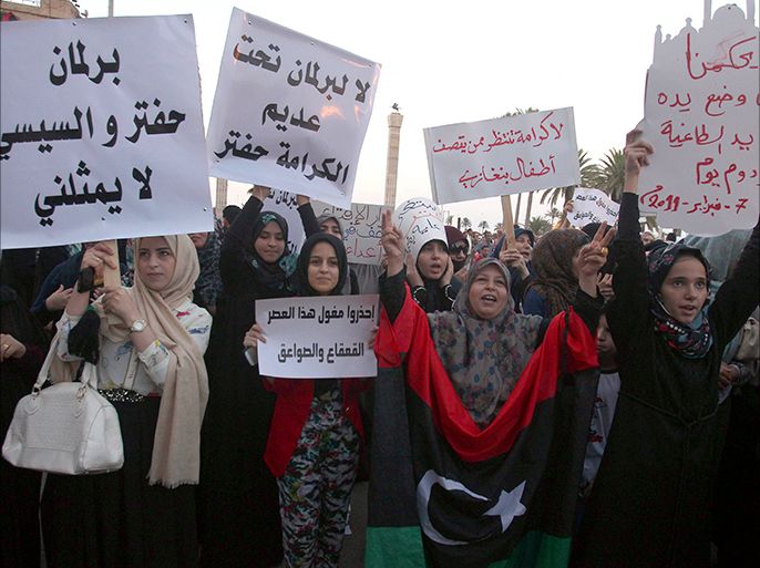 epa04346905 A picture made available on 09 August 2014 shows Libyan women holding placards criticising the new House of Representatives as they shout slogans during a demonstration in Tripoli, Libya, 08 August 2014. Thousands of Libyans rallied to ptotest against the newly elected parliament met in Tobruk and against the 'Operation Dignity', a large scale air and ground offensive launched by Libyan army soldiers. Staff of the UN and other foreign and international missions, have been evacuated from the country amid escalations of recent violence. EPA/SABRI ELMHEDWI