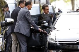 Former French President Nicolas Sarkozy enters his car as he leaves a restaurant in Paris September 19, 2014. France's former president Nicolas Sarkozy announced his return to politics on Friday, declaring he would seek the leadership of the opposition UMP in a move that would position him for a 2017 presidential bid. The announcement on his Facebook page ends months of local media speculation that the 59-year-old conservative would return to the fray after his defeat by Socialist Francois Hollande in 2012. Sarkozy said "I am a candidate for the presidency of my political family". REUTERS/Charles Platiau (FRANCE - Tags: POLITICS)
