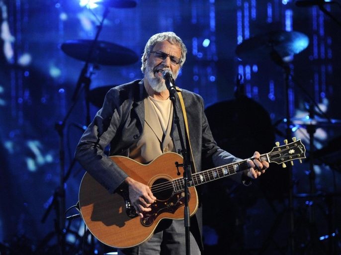 FILE - In this April 10, 2014 file photo, Hall of Fame Inductee Cat Stevens performs at the 2014 Rock and Roll Hall of Fame Induction Ceremony in New York. Stevens is taking the "Peace Train" back on the road. He announced Monday, Sept. 15, that he will make a brief concert tour in North America this December. He's also releasing a blues album in October produced by Rick Rubin. (Photo by Charles Sykes/Invision/AP, File)