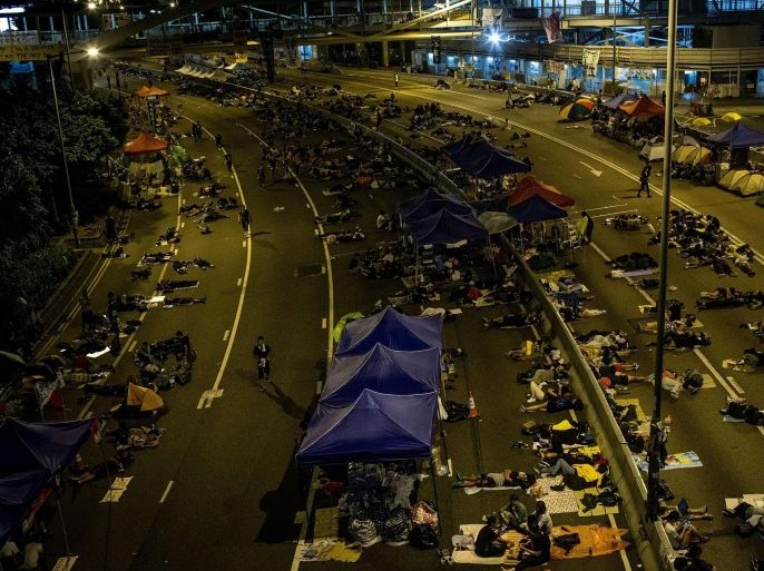 HONG KONG - OCTOBER 06: A general view as pro-democracy protesters sleep on the streets outside the Hong Kong Government complex on October 6, 2014 in Hong Kong, Hong Kong. Thousands of pro democracy supporters continue to occupy the streets surrounding Hong Kong's Financial district. The protesters are calling for open elections and the resignation of Hong Kong's Chief Executive Leung Chun-ying.
