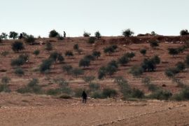 Alleged Islamic State (IS) militants stand on a hill on the western outskirts of the Syrian town of Kobane, also known as Ain al-Arab, on October 18, 2014 as seen from the Turkish side of the border. Turkey is turning a deaf ear to insistent pressure to take a more pro-active stance in the fight against Islamic State (IS) jihadists, adding to existing strains with the West under President Recep Tayyip Erdogan. Western diplomats have repeatedly made clear they want to see the key NATO member play a key role in the coalition against the militants, who are battling for the Syrian town Kobane just a few kilometers from Turkey. AFP PHOTO / ARIS MESSINIS