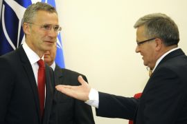 Polish President Bronislaw Komorowski, right, gestures before talks with NATO Secretary General Jens Stoltenberg, left, in Warsaw, Poland, Monday, Oct. 6, 2014. Stoltenberg came to Poland for his first visit abroad after taking over the leadership of the alliance. (AP Photo/Alik Keplicz)