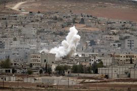 Smoke from a fire rises following a strike in Kobani, Syria, during fighting between Syrian Kurds and the militants of Islamic State group, as seen from a hilltop on the outskirts of Suruc, at the Turkey-Syria border, Sunday, Oct. 19, 2014. Kobani, also known as Ayn Arab, and its surrounding areas, has been under assault by extremists of the Islamic State group since mid-September and is being defended by Kurdish fighters. (AP Photo/Lefteris Pitarakis)