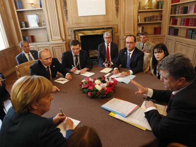 Ukrainian President Petro Poroshenko, right, talks to Russian President Vladimir Putin, left, as they meet with German Chancellor Angela Merkel, left back to camera, and French President Francois Hollande, center face to camera, in Milan, Italy, Friday, Oct.17, 2014. The 10th Asia-Europe Meeting (ASEM) took place in Milan, Italy on Thursday 16 and Friday 17 October, 2014, under the theme "Responsible Partnership for Sustainable Growth and Security". (AP Photo/Luca Bruno)
