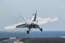 In this photo taken Friday, Oct. 10, 2014, a U.S. Navy aircraft launches from the aircraft carrier USS George H.W. Bush in the Persian Gulf. On Thursday, Oct. 16, the U.S. conducted 14 airstrikes, hitting buildings controlled by the Islamic State group, sniping positions and a heavy machine gun, according to a statement issued by the U.S. military's central command. Over the last two weeks, U.S airstrikes in support of Kurdish fighters in the embattled border town of Kobani, Syria, have killed hundreds of Islamic State fighters, said Rear Adm. John Kirby. (AP Photo/Brian Stephen, U.S. Navy)