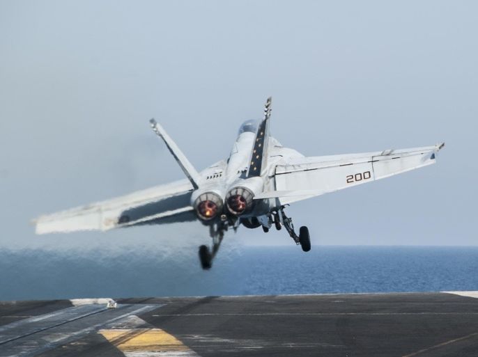 In this photo taken Friday, Oct. 10, 2014, a U.S. Navy aircraft launches from the aircraft carrier USS George H.W. Bush in the Persian Gulf. On Thursday, Oct. 16, the U.S. conducted 14 airstrikes, hitting buildings controlled by the Islamic State group, sniping positions and a heavy machine gun, according to a statement issued by the U.S. military's central command. Over the last two weeks, U.S airstrikes in support of Kurdish fighters in the embattled border town of Kobani, Syria, have killed hundreds of Islamic State fighters, said Rear Adm. John Kirby. (AP Photo/Brian Stephen, U.S. Navy)