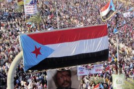 The flag of former South Yemen is seen attached to a billboard during a rally in Yemen's southern port city of Aden October 14, 2014. The rally was held to call for the secession of Yemen's south region. REUTERS/Yaser Hasan (YEMEN - Tags: POLITICS CIVIL UNREST)