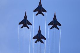 Russian aerobatic team Strizhi (The Swifts) performs on MIG-29s during a military parade to mark 70 years since the city's liberation by the Red Army in Belgrade October 16, 2014. Serbia feted Russia's Vladimir Putin with troops, tanks and fighter-jets on Thursday to mark seven decades since the Red Army liberated Belgrade, balancing its ambitions of European integration with enduring reverence for a big-power ally deeply at odds with the West. REUTERS/Marko Djurica (SERBIA - Tags: POLITICS MILITARY ANNIVERSARY TRANSPORT)