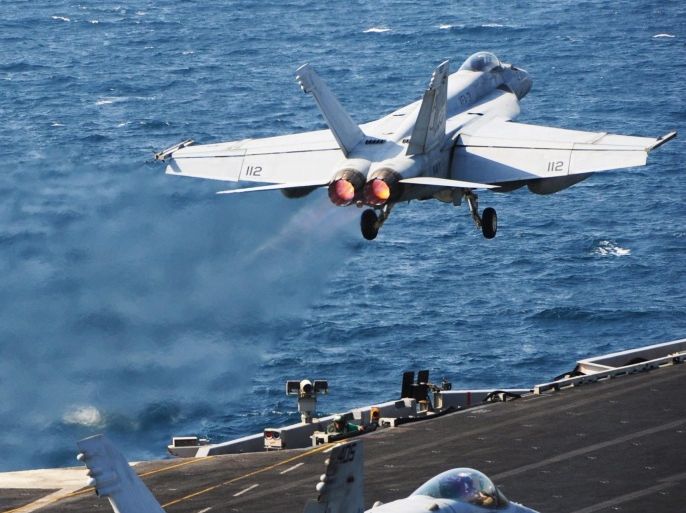 A handout picture made available by the US Department of Defense (DOD) shows an F/A-18E Super Hornet assigned to the Tomcatters of Strike Fighter Squadron (VFA) 31 launching from the flight deck of the aircraft carrier USS George H.W. Bush (CVN 77) at sea in the Arabian Gulf, 13 October 2014. George H.W. Bush is supporting maritime security operations, strike operations in Iraq and Syria as directed, and theater security cooperation efforts in the US 5th Fleet area of responsibility. The coalition fighting Islamic State (IS or ISIS) militants is prepared for a long-term effort, US President Barack Obama said on 14 October as military leaders from 21 countries met outside Washington. The coalition is focused on fighting in Iraq's Anbar province and in the Syrian town of Kobane, Obama says, noting airstrikes will continue in those areas. EPA/DOD/US NAVY/JOSHUA CARD