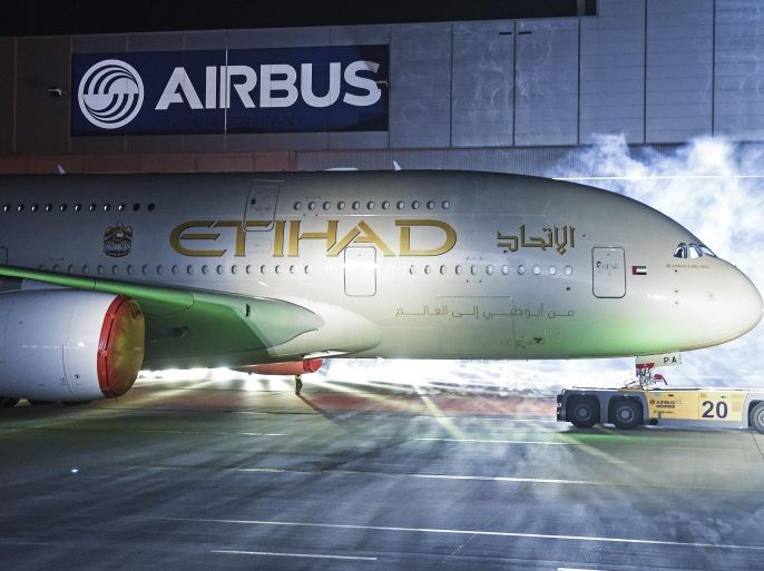 An Airbus A380 rolls out of a paint hangar during a branding ceremony of Etihad Airways, the national airline of the United Arab Emirates (UAE), at the German headquarters of aircraft company Airbus, in Hamburg-Finkenwerder September 25, 2014. Abu Dhabi's state-owned Etihad Airways showed off its first A380 super jumbo and unveiled its new branding on Thursday as it seeks to up the battle in the luxury stakes and continue its rapid growth. REUTERS/Fabian Bimmer (GERMANY - Tags: TRANSPORT BUSINESS)