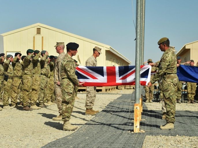 A handout image made available by British Defence Ministry, MOD, dated 26 October 2014 and showing British soldiers and US Marine Corps (USMC) soldiers attending the ceremony of the British, US and NATO flags being lowered at the Camp Bastion-Leatherneck camp complex for the last time in Afghanistan. British Armed Forces have ended combat operations in Helmand Province in Afghanistan, paving the way for the final transfer of security to the Afghan National Security Forces (ANSF).The ceremony was alo attended by troops of Afghan National Security Forces (ANSF). The ceremony marks the end of operations for Regional Command (Southwest), a British and US coalition command under the umbrella of NATOs International Security Assistance Force (ISAF). Other contributing nations have included Denmark, Estonia, Georgia, Tonga, Jordan and Bosnia. EPA/SERGEANT OBI IGBO, RLC / MOD / HANDOUT