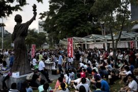 Students at the Chinese University of Hong Kong meet next to a replica of the 'Goddess of Democracy' statue (L) to discuss a possible student strike in Hong Kong on September 4, 2014. A group of Hong Kong students on September 4 proposed plans to hold a week-long strike later in the month in response to Beijing's refusal to grant the semi-autonomous city full universal suffrage. AFP PHOTO / ALEX OGLE