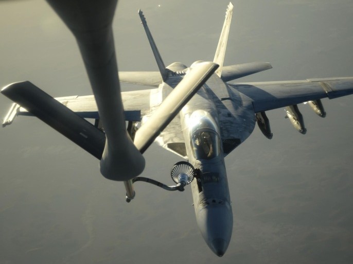 A U.S. Navy F-18E Super Hornet receives fuel from a KC-135 Stratotanker over northern Iraq after conducting air strikes in Syria on September 23, 2014. These aircraft were part of a large coalition strike package that was the first to strike ISIL targets in Syria. Picture taken on September 23, 2014. REUTERS/Shawn Nickel/(U.S. Air Force/Handout (IRAQ - Tags: MILITARY CONFLICT) FOR EDITORIAL USE ONLY. NOT FOR SALE FOR MARKETING OR ADVERTISING CAMPAIGNS. THIS IMAGE HAS BEEN SUPPLIED BY A THIRD PARTY. IT IS DISTRIBUTED, EXACTLY AS RECEIVED BY REUTERS, AS A SERVICE TO CLIENTS
