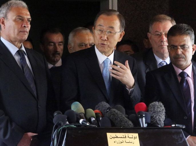 United Nations Secretary-General Ban Ki-moon (C) speaks to the media during his visit to the headquarters of the Palestinian cabinet in Gaza City October 14, 2014. Ban Ki-moon lamented the vast destruction in Gaza as he visited the area on Tuesday for the first time since the war, calling the situation "beyond description" and urging a speedy reconstruction effort. He also announced that Israel was permitting a first truckload of construction materials to enter the enclave, which has been blockaded by Israel and Egypt since before the conflict. REUTERS/Ibraheem Abu Mustafa (GAZA - Tags: POLITICS CIVIL UNREST)