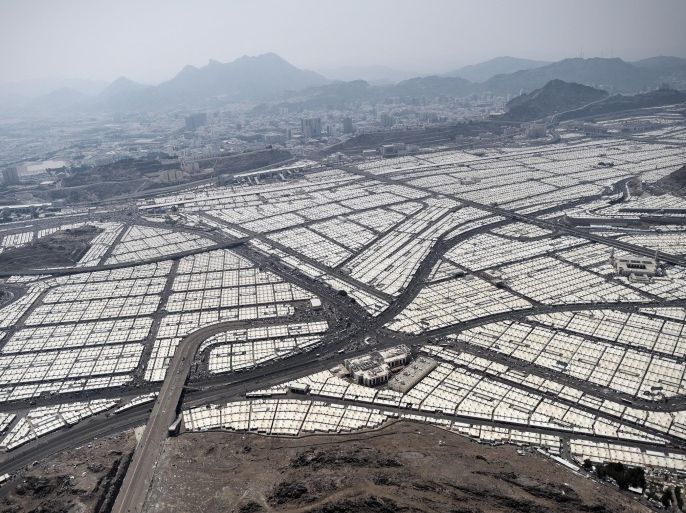 An aerial view shows tens of thousands of tents hosting piligrms in Mina near the holy city of Mecca, on October 5, 2014. Pilgrims pelt pillars symbolizing the devil with pebbles to show their defiance on the third day of the hajj as Muslims worldwide mark the Eid al-Adha or the Feast of the Sacrifice, marking the end of the hajj pilgrimage to Mecca and commemorating Abraham's willingness to sacrifice his son Ismail on God's command in the holy city of Mecca. AFP PHOTO/MOHAMMED AL-SHAIKH