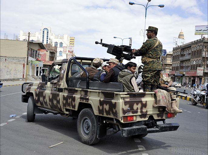 epa04446326 Members of the Shiite Houthi militias patrol a street in Sana?a, Yemen, 14 October 2014. According to media reports the Shiite Houthi movement have not only retained control of their checkpoints in Sana'a despite a ceasfire argreement which should have seen the militias leave the city, but also captured the strategically important Red Sea port town of Hodeida, home to Yemen's largest oil refinery and responsible for the bulk of the country's oil exports, the soldiers loyal to the Shiite Houthi movement now occupy the town's port, airport and took over an army base gaining access to weapons and ammunition. EPA/YAHYA ARHAB